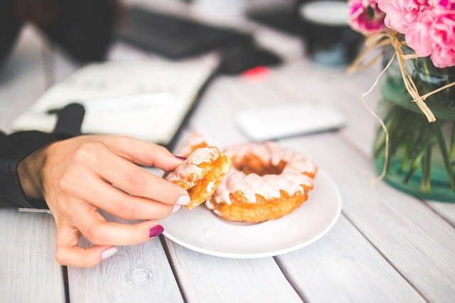 Emotionales Essen - eine Frau isst einen Donut